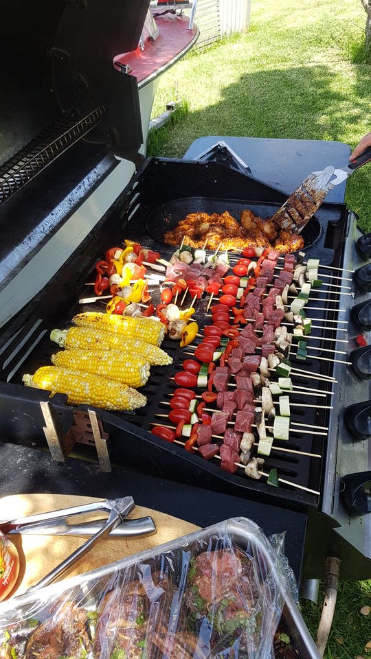 Kebabs and corn cooking on the BBQ