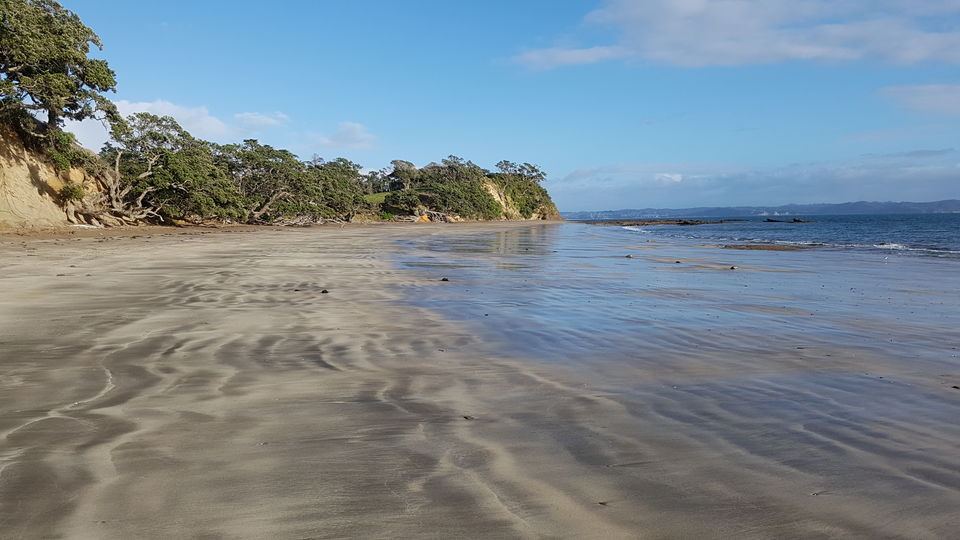 The secluded sandy beach at low tide