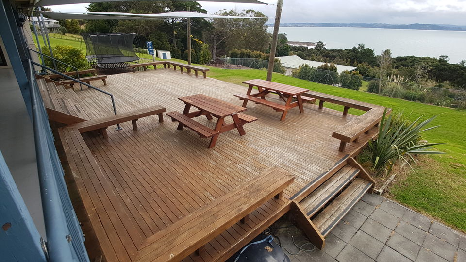 The large deck with picnic tables, looking out over the water