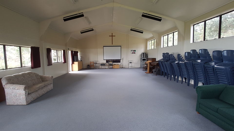 The recreation hall interior with stacked chairs and sofas